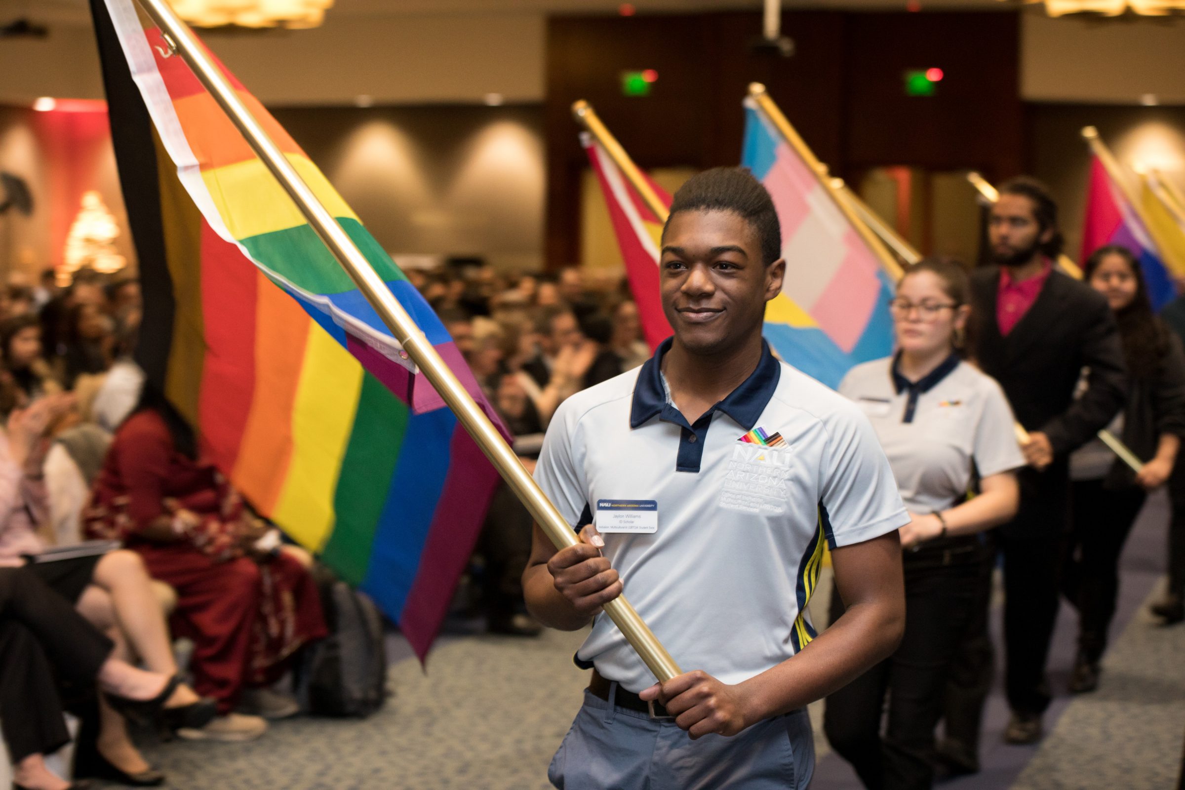Students lined up with different symbolic flags at a diversity event.