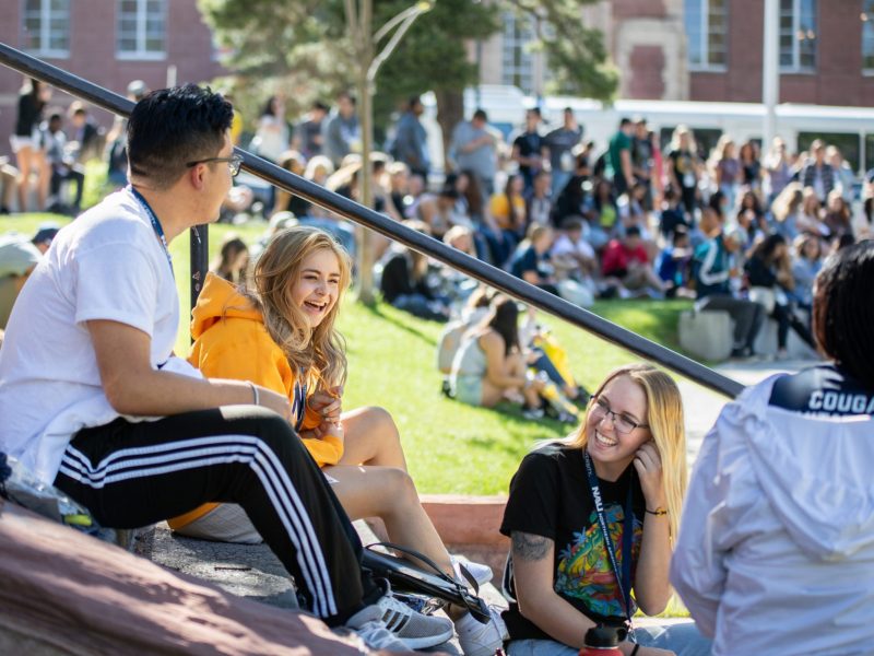 New students of Northern Arizona University sitting outside Flagstaff campus during orientation.