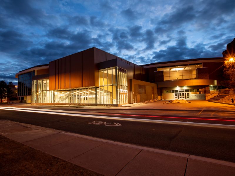 Kitt Recital Hall with exterior lighting against the evening sky.