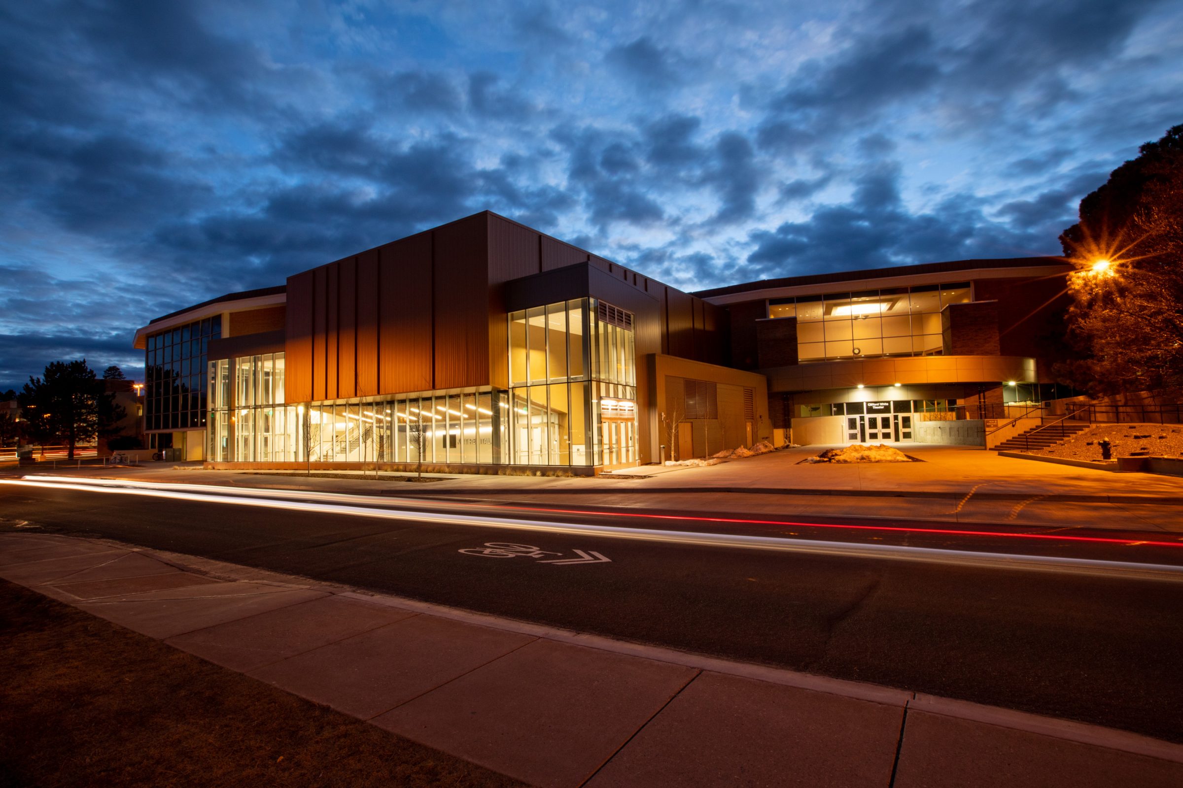 Kitt Recital Hall with exterior lighting against the evening sky.