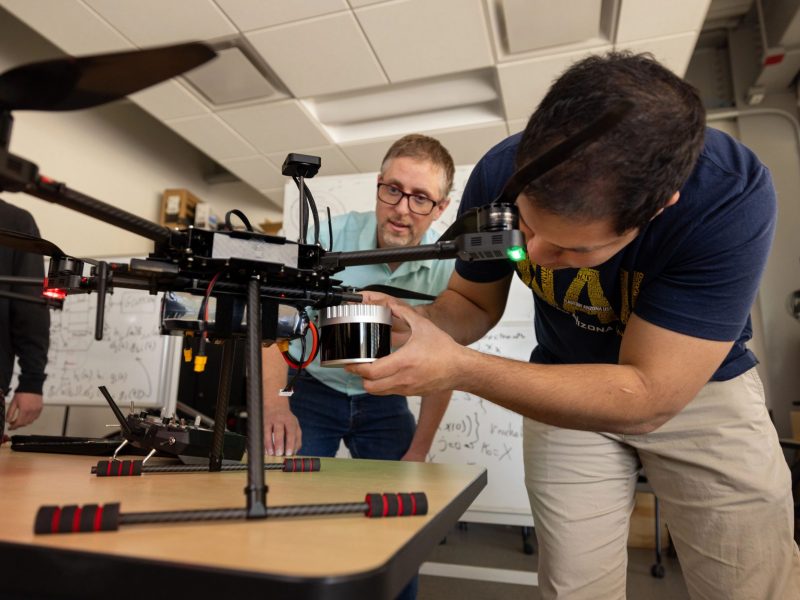 Students working on a drone in the SICCS lab.