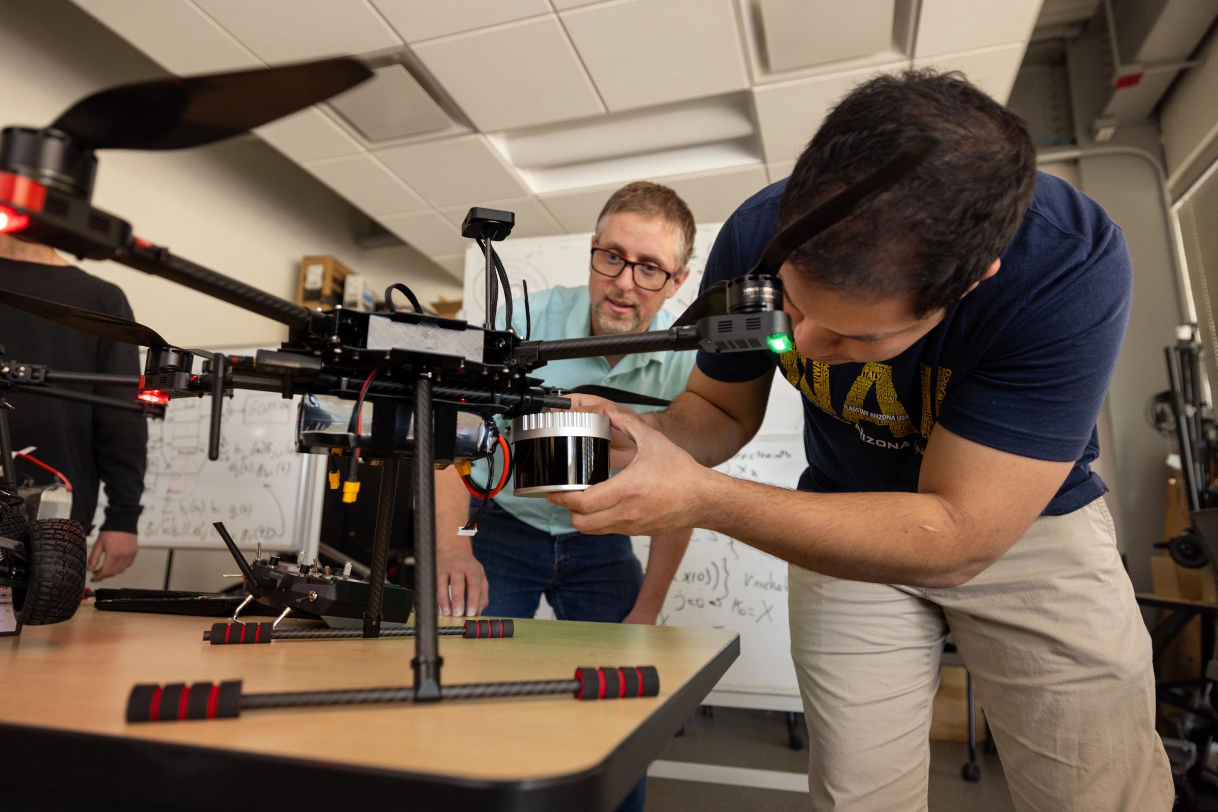 Students working on a drone in the SICCS lab.