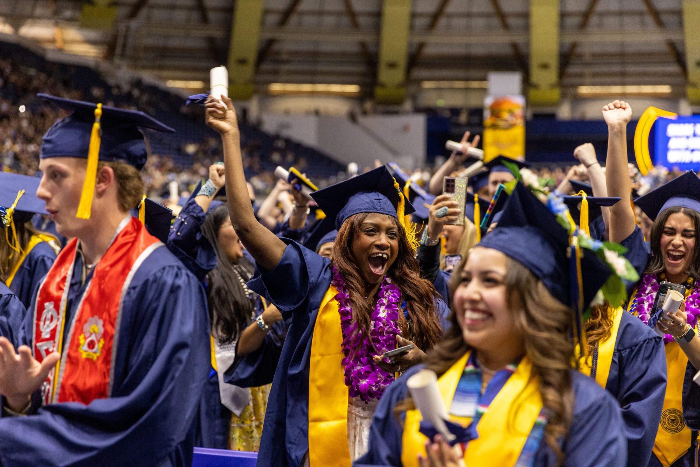 students_celebrating_at_commencement-scaled.jpg