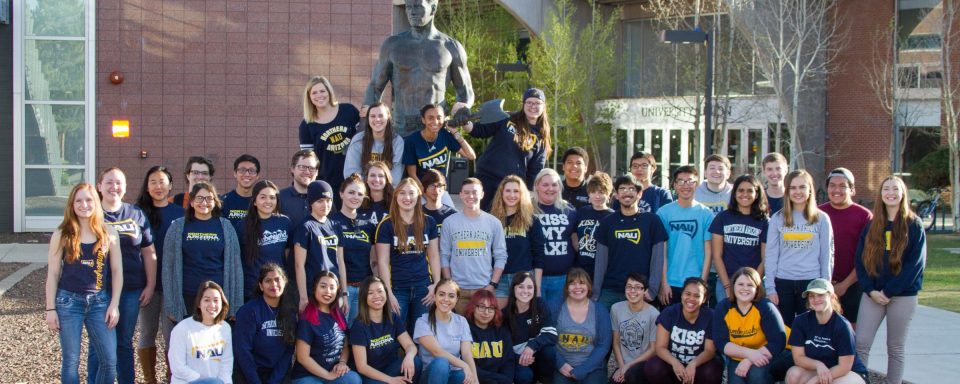 NAU math students posing in front of the lumberjack statue 