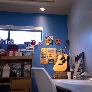 An acoustic guitar on top of a table in an activity room