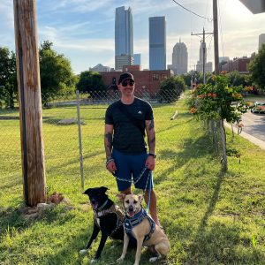 Mike Anastario and his two dogs posed outside in Oklahoma City