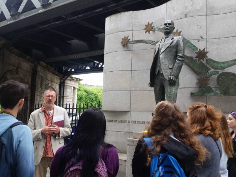 Photos of students in the study abroad program listening to a presentation at the James Connolly Statue.