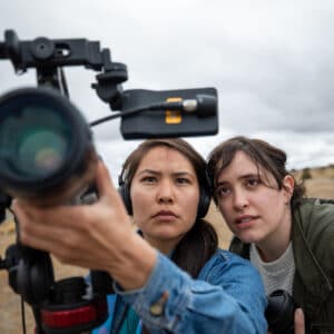 Two students filming outside.