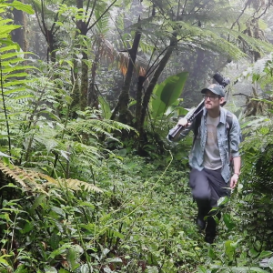 Trevor Ritland walking through a rainforest.