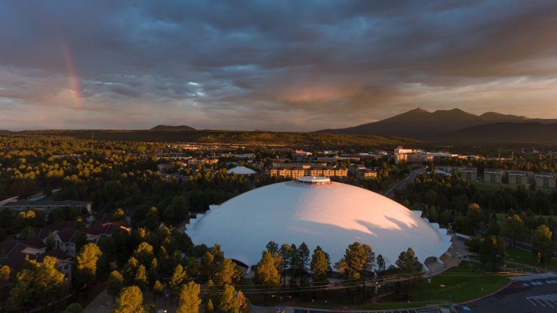 Aerial view of Northern Arizona University campus showing the Skydome and the San Francisco Peaks