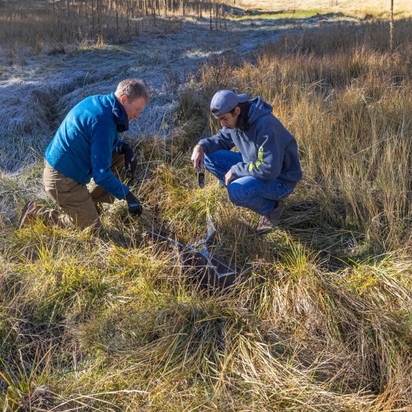 Professor Abe Springer and graduate assistant Andrew Lewis studying in the field.