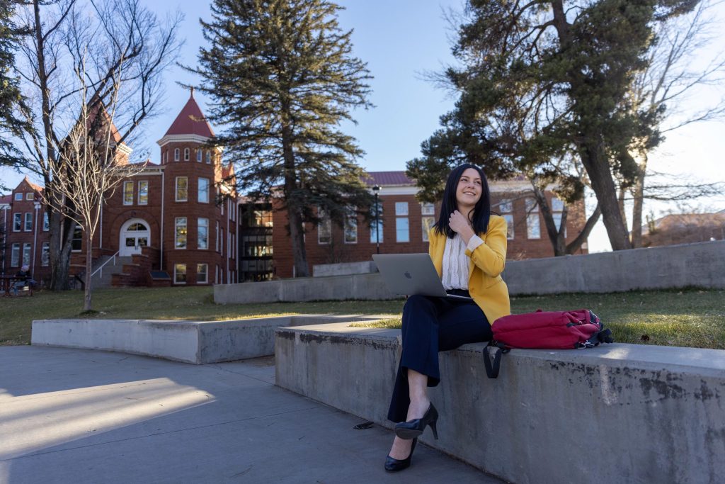 Rachel Kanyur in front of the Old Main building on NAU's Flagstaff campus.