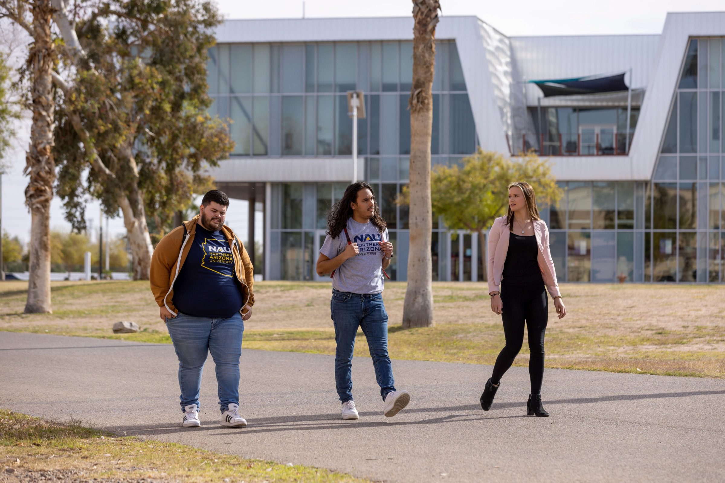 Kacey Cordell and two other students walk across NAU–Yuma campus.
