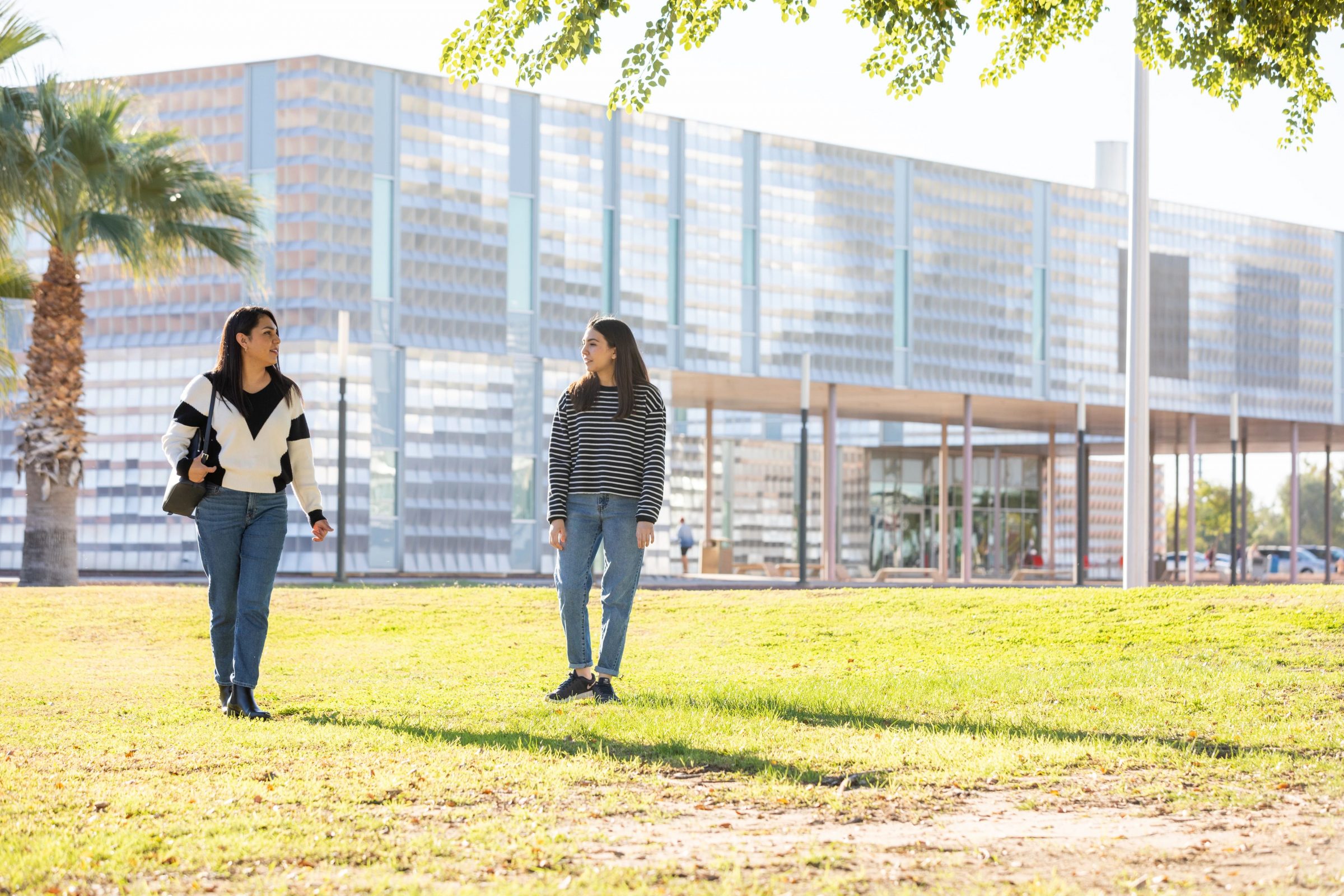 Two students walking on NAU-Yuma's campus.