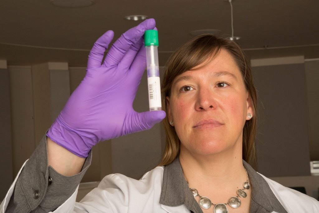 Associate Professor Bridget Barker looking at lab sample.
