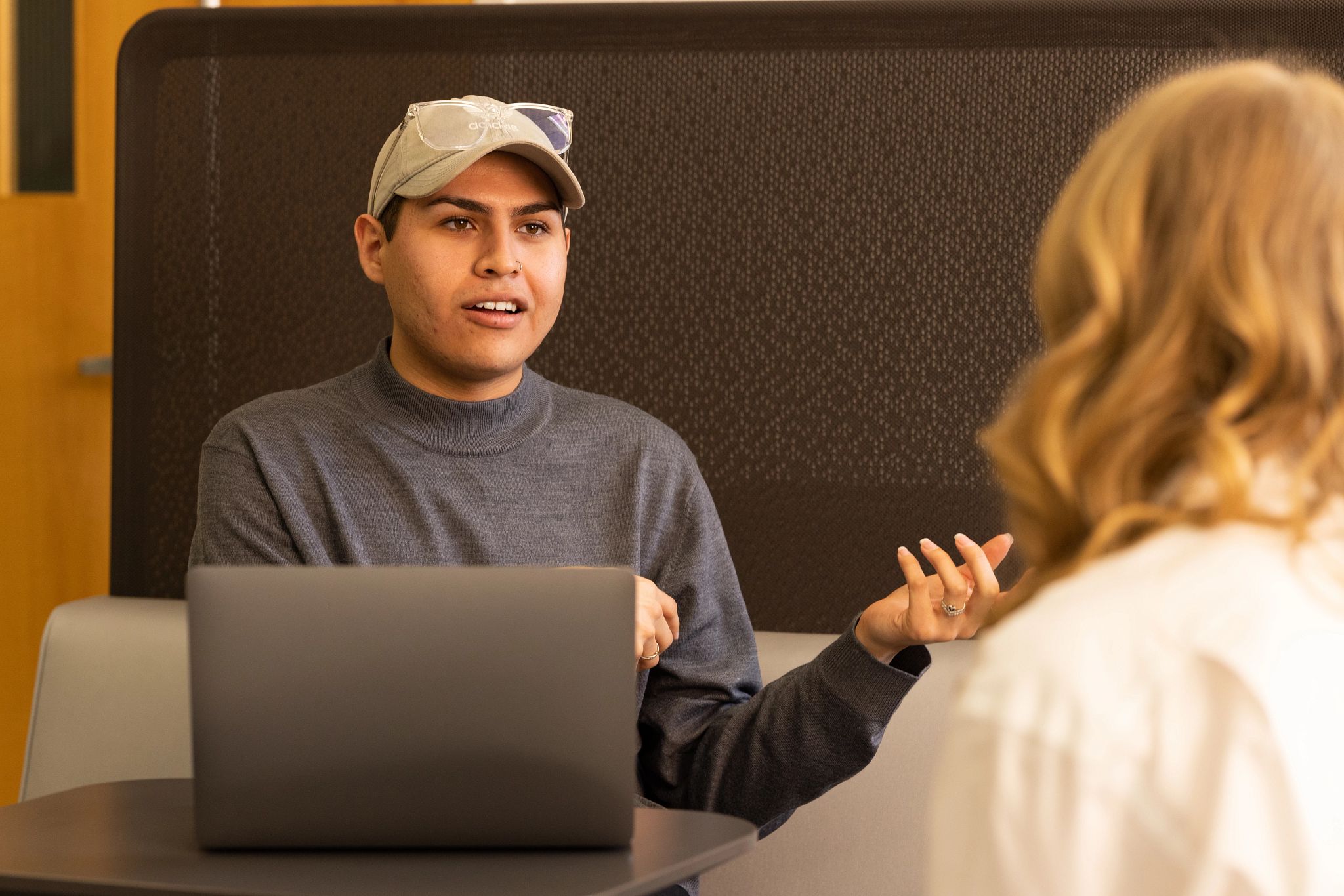 Biomedical sciences student Andres Huerta talking with colleague.