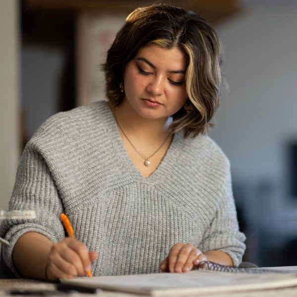 Undergraduate art student, Ehsa Murray, works in her sketchbook.