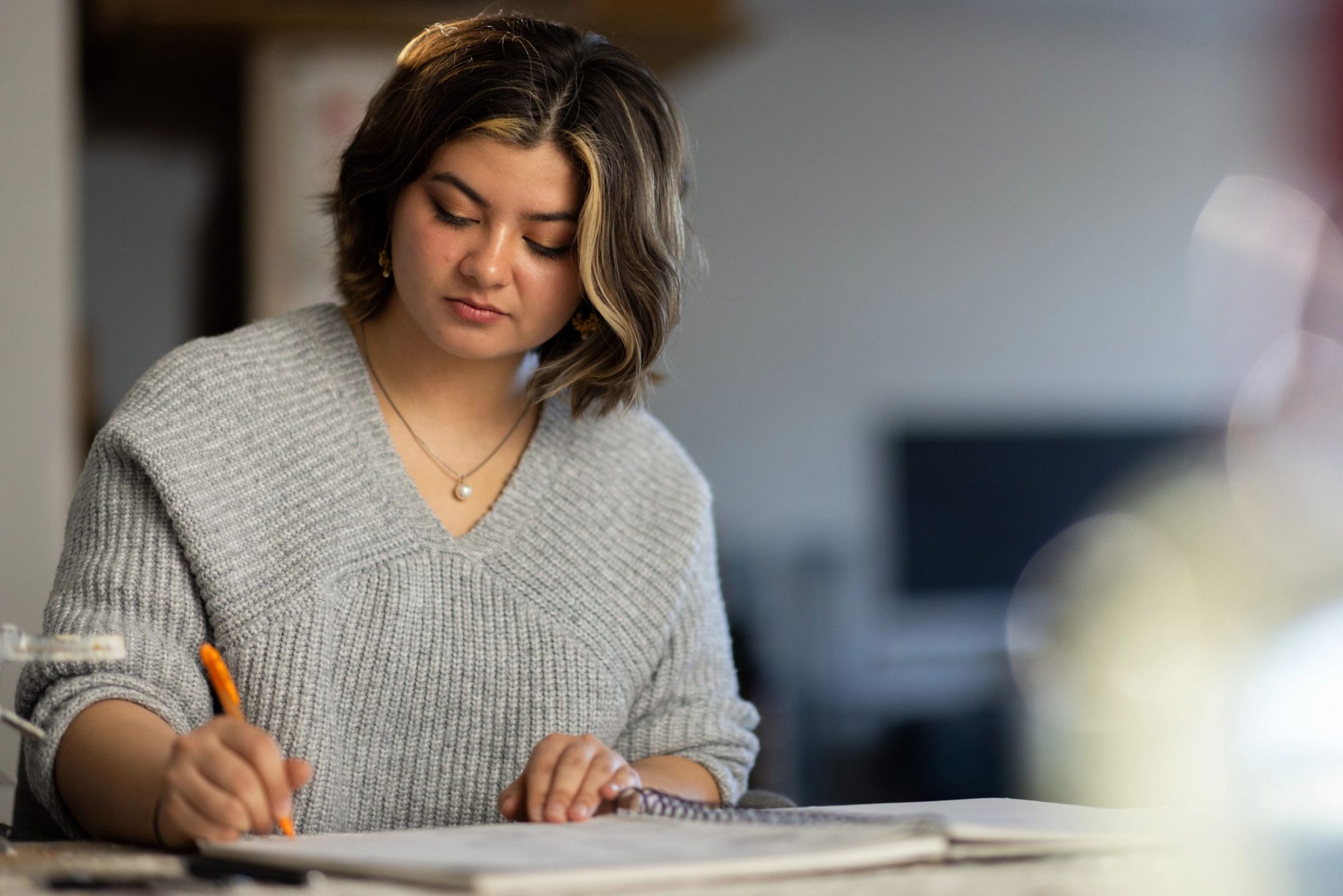 Undergraduate art student, Ehsa Murray, works in her sketchbook.