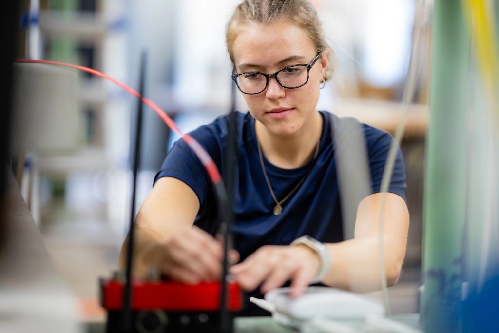 Civil Engineer major Jenna Hays connects wire in lab.