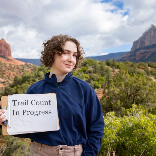 Helena Moomjian holding a clipboard that says "Trail count in progress."