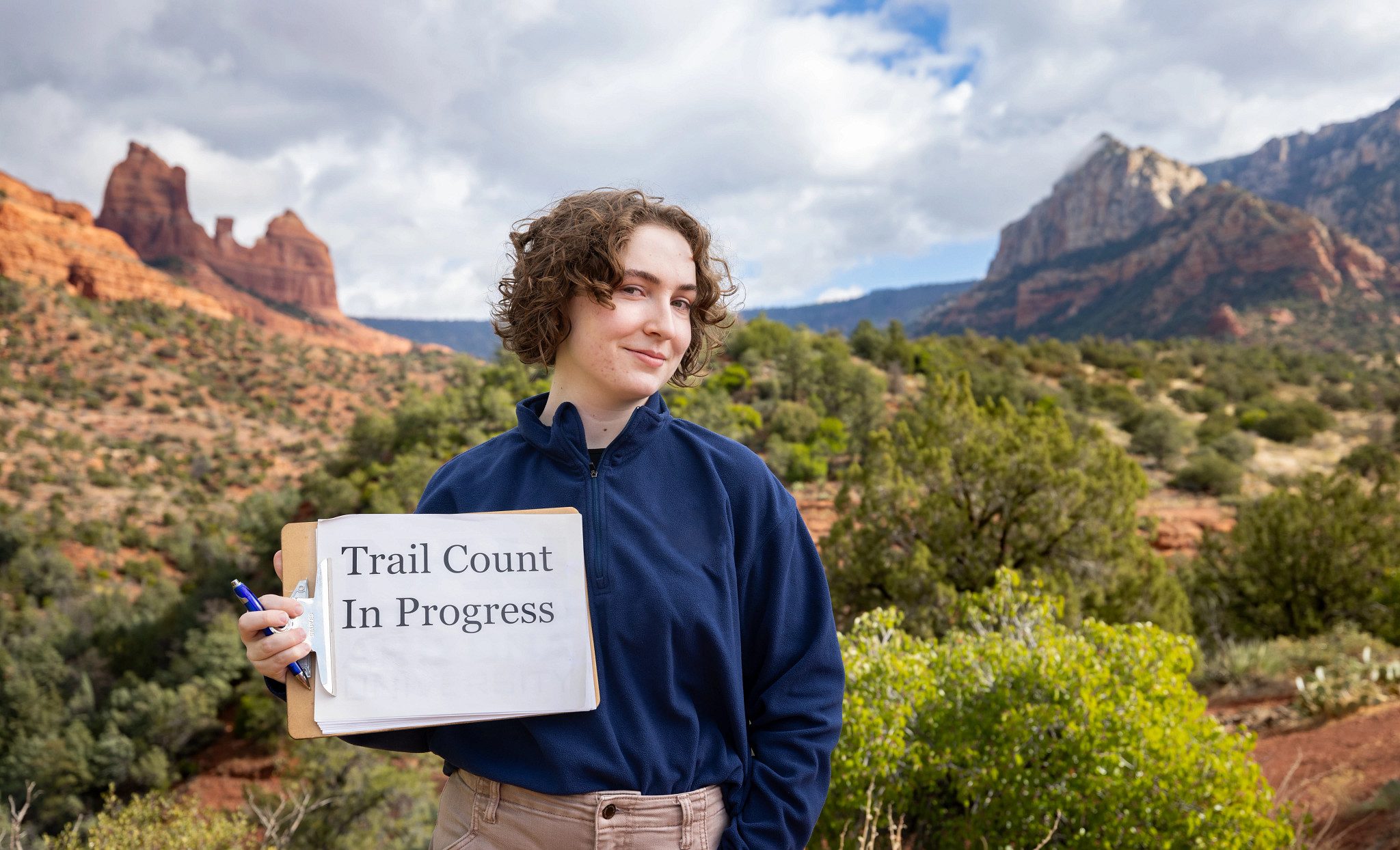 Helena Moomjian holding a clipboard that says "Trail count in progress."