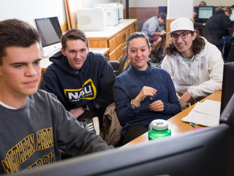 NAU students looking at a computer screen