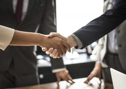 Two people shaking hands on an agreement.