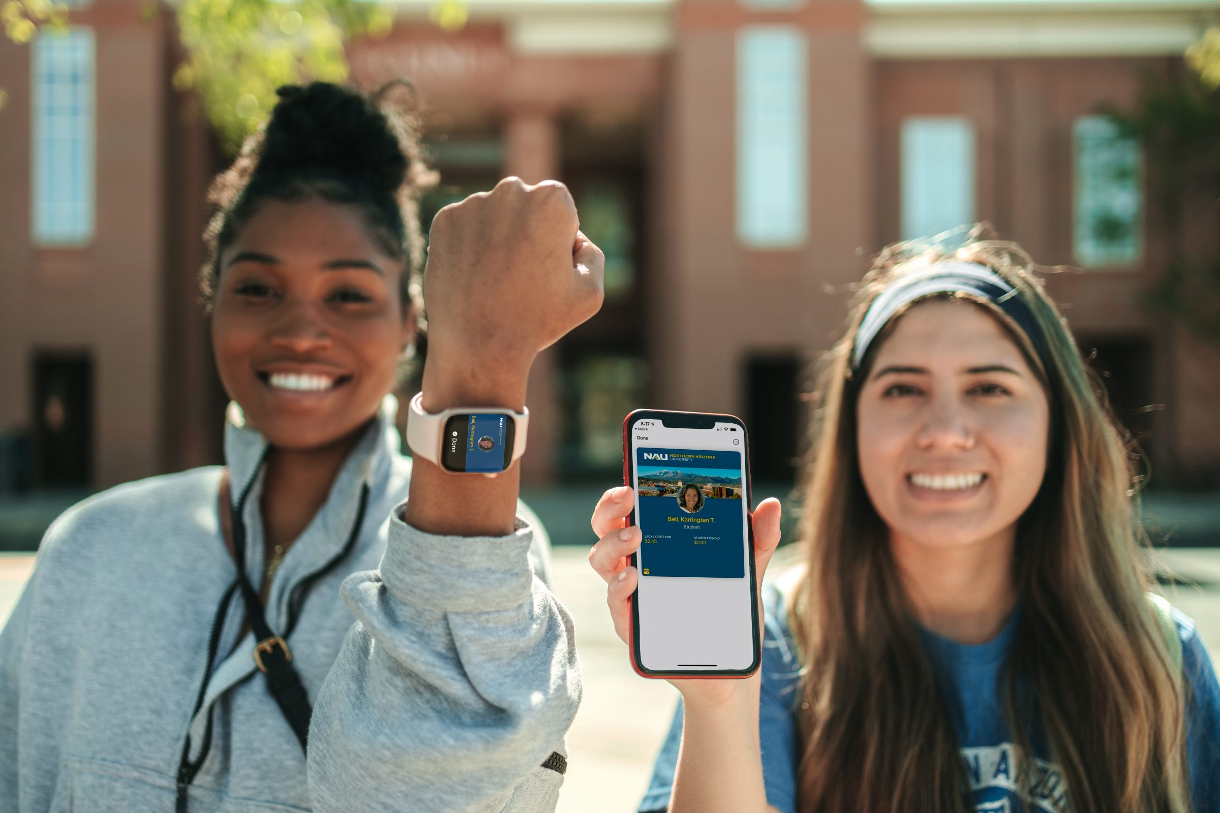Two students with an Apple device and Apple watch