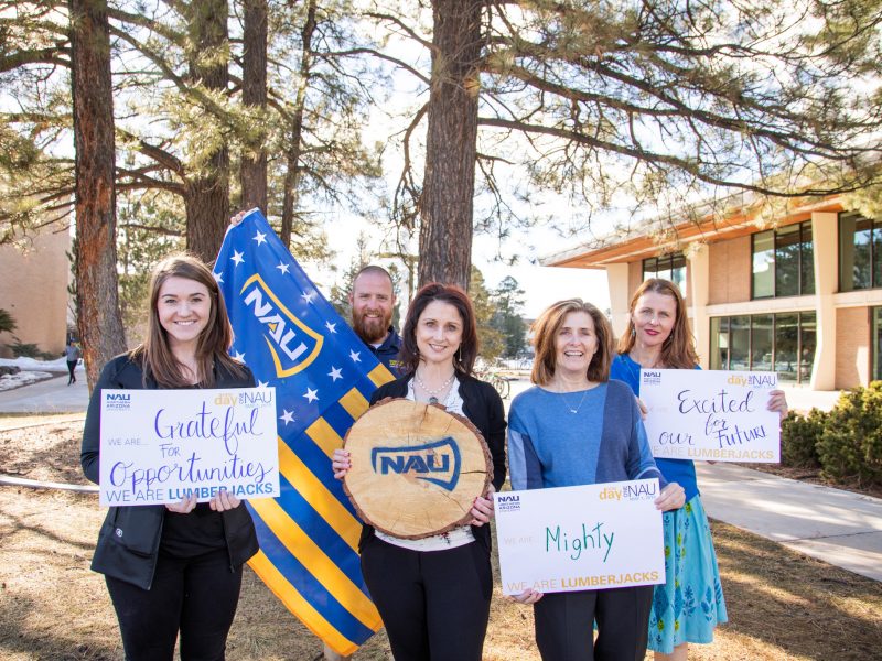 A group of N A U faculty proudly show off their Northern Arizona University pride.
