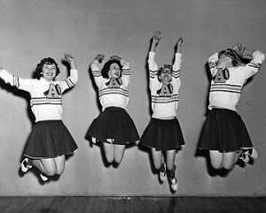 ASC Cheer Squad wearing uniforms featuring N A U's pre-1966 Megaphone symbol. 