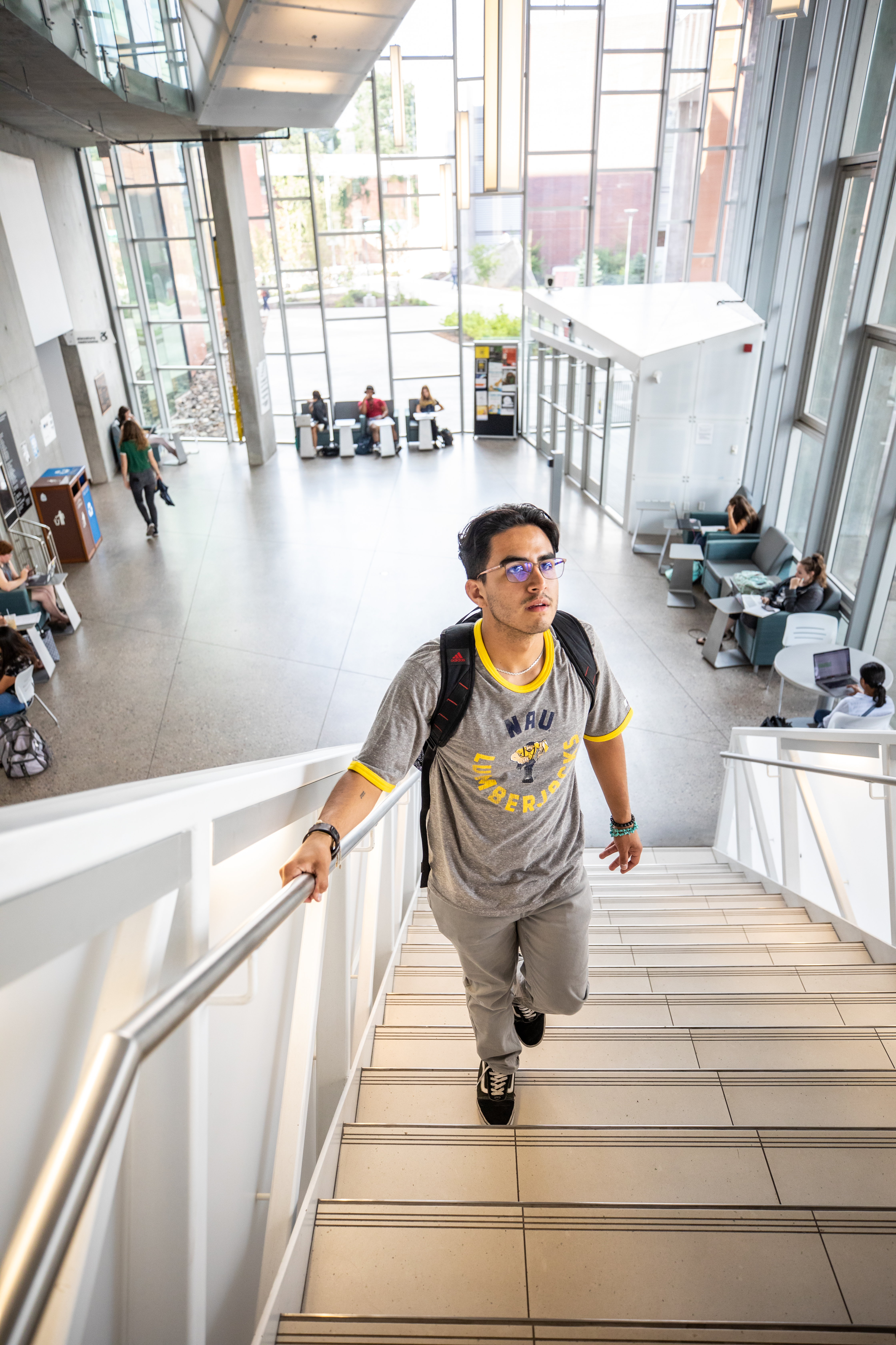 Student walking up stairs in the Health and Science building.