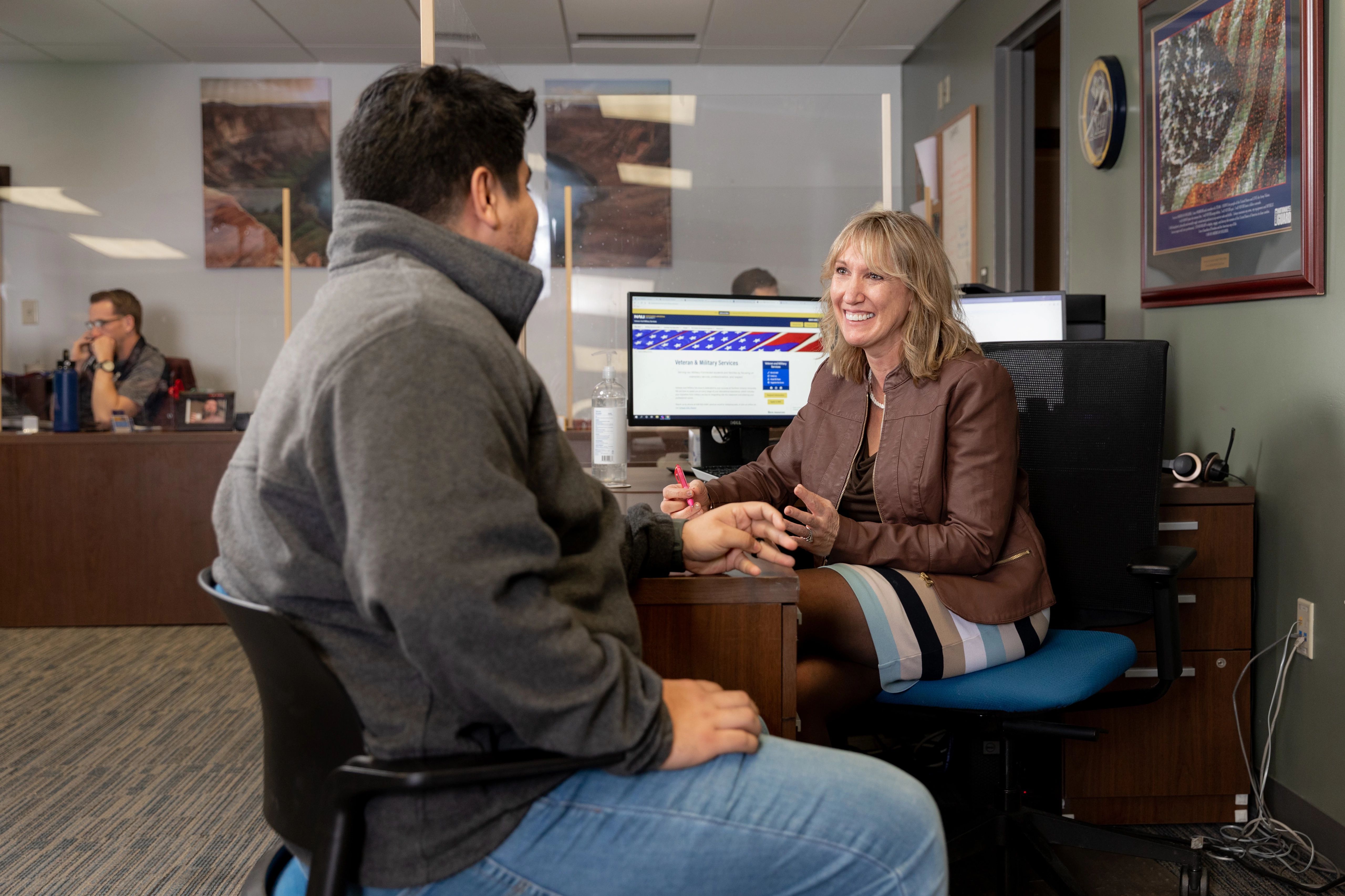 An NAU student meets with an advisor in the veteran success center.