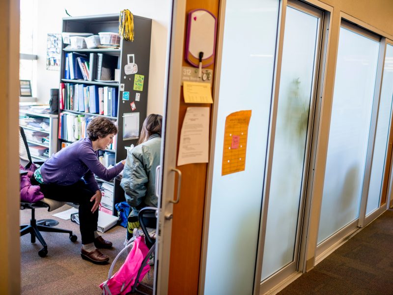 An instructor assisting a student in the instructor's office.