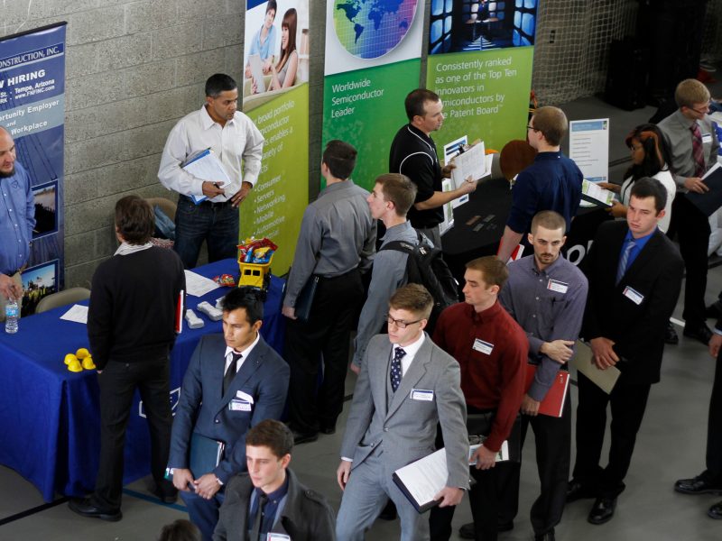 The W A Franke College of Business students walking through the crowd at a career fair.