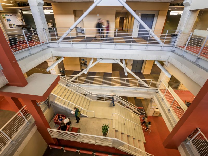 View looking down from the top level of The W A Franke College of Business building, showing multiple floors of classrooms.