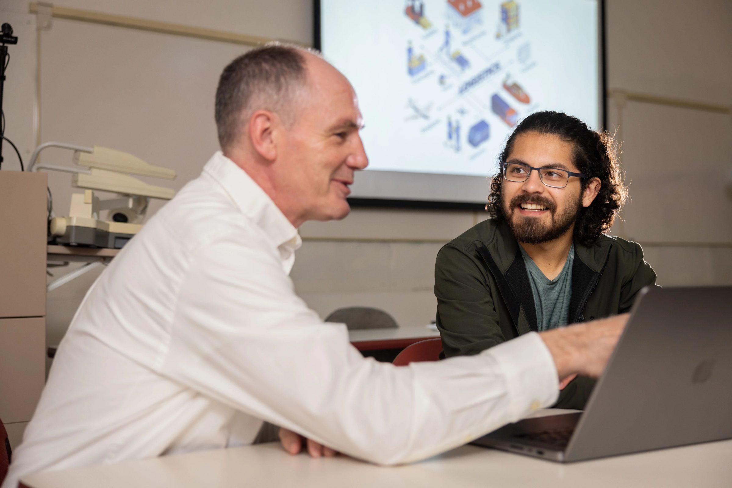 Student learning from a professor on N A U Yuma campus