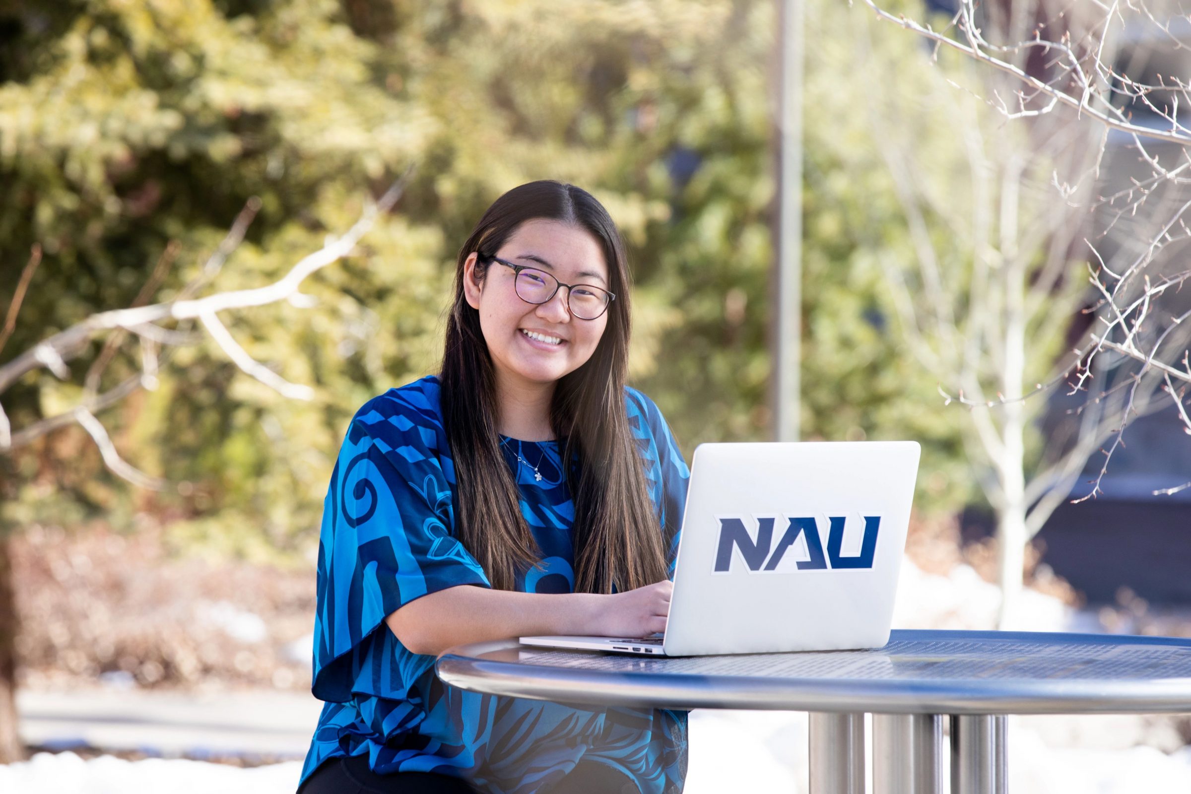 N A U student studying outside on campus