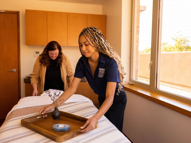 H R M student setting up a spa environment at enchantment.