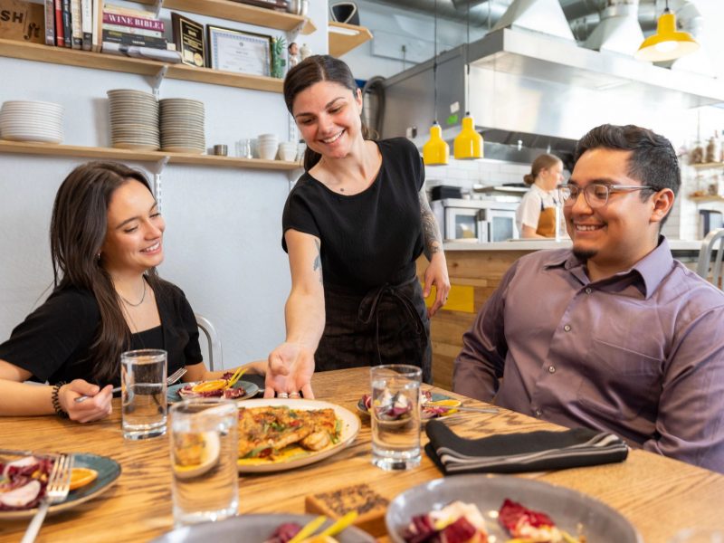 H R M student serving customers food on N A U campus