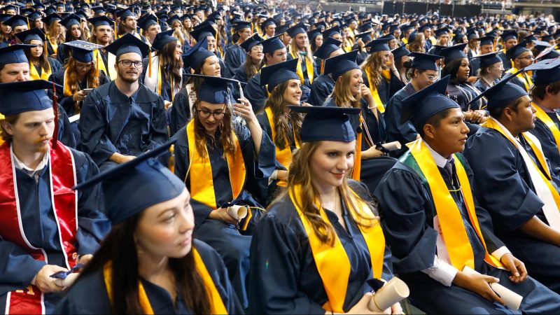 Students sitting at commencement.