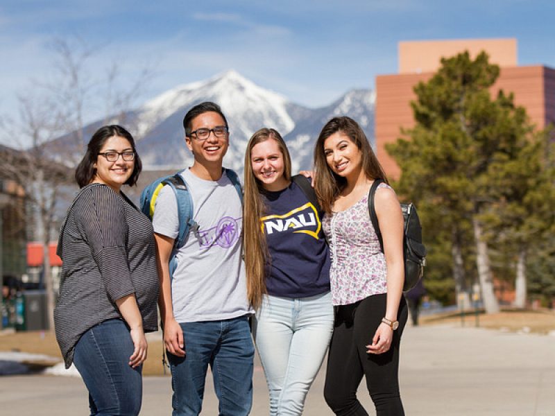 4 students standing outside on the N A U campus.