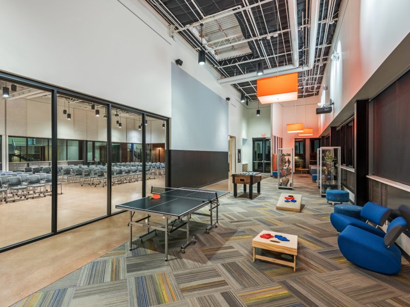 Hybrid area at the NAU International Pavilion featuring a conference room alongside a game room equipped with an audio-visual setup.