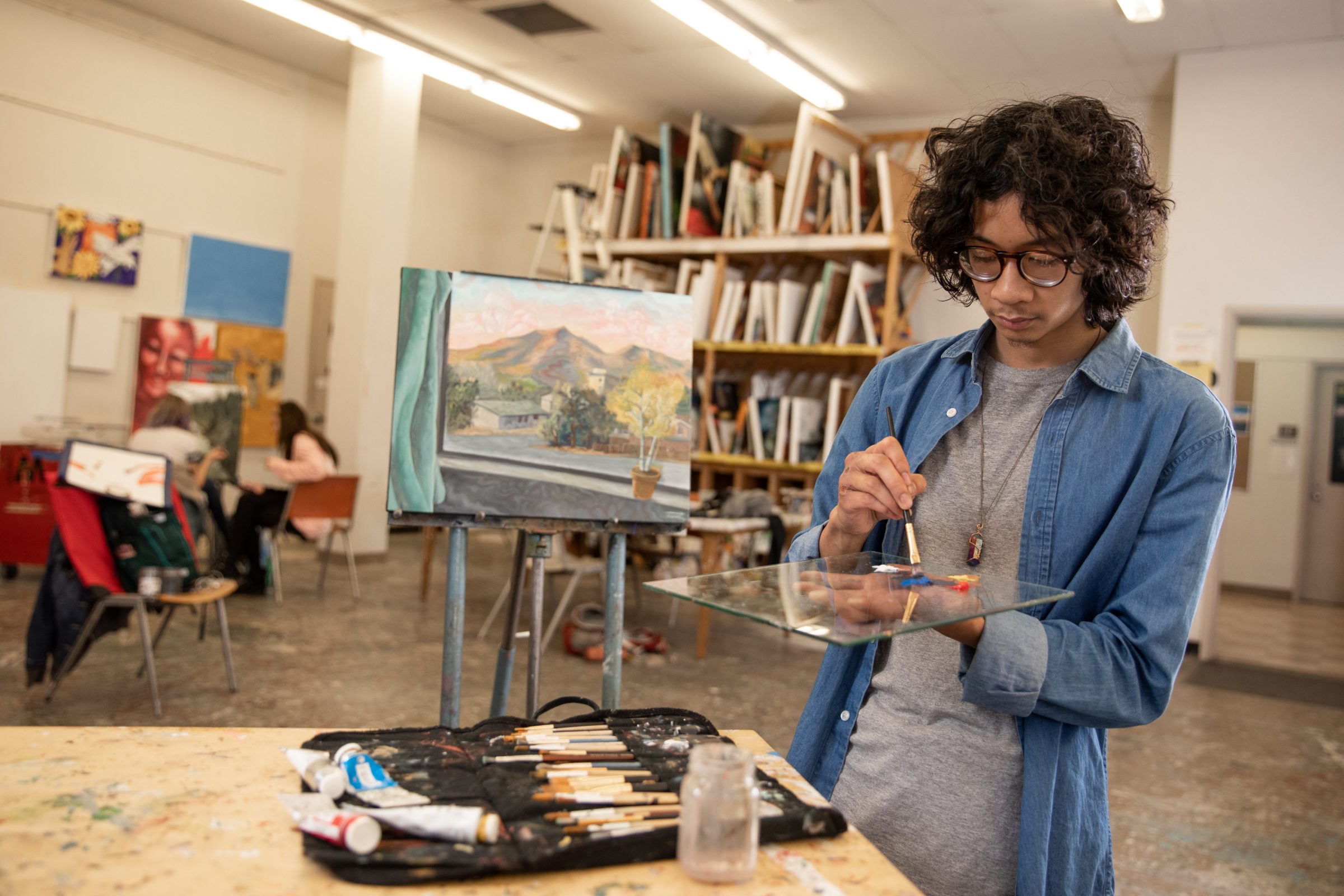 A Fine Arts student working on a painting.