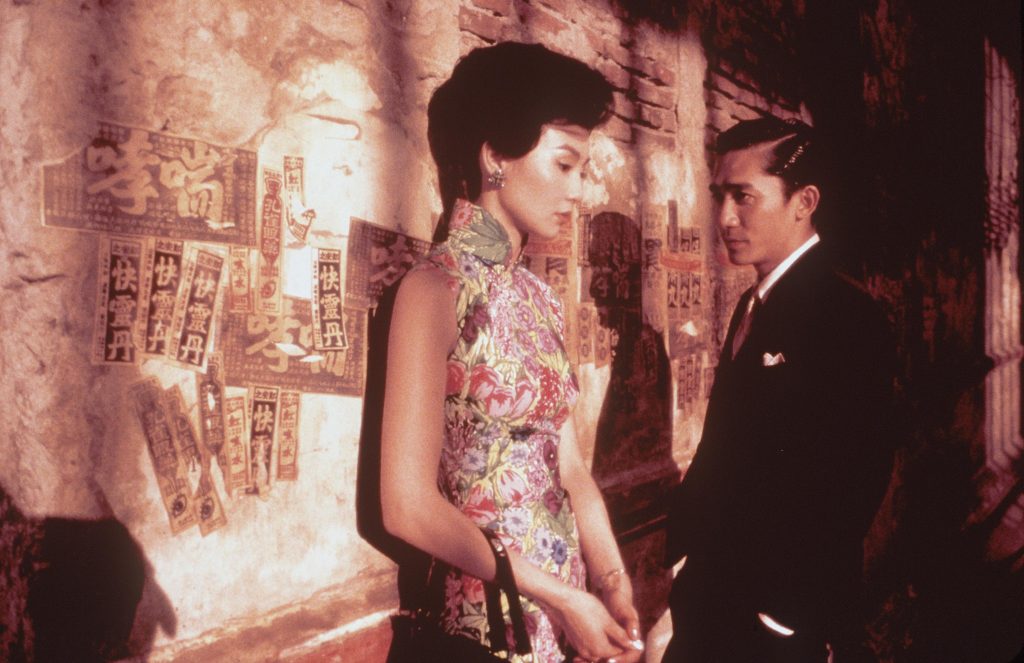 Tony Leung and Maggie Cheung pose in a darkened alley wearing gorgeous formal attire in "In the Mood for Love."