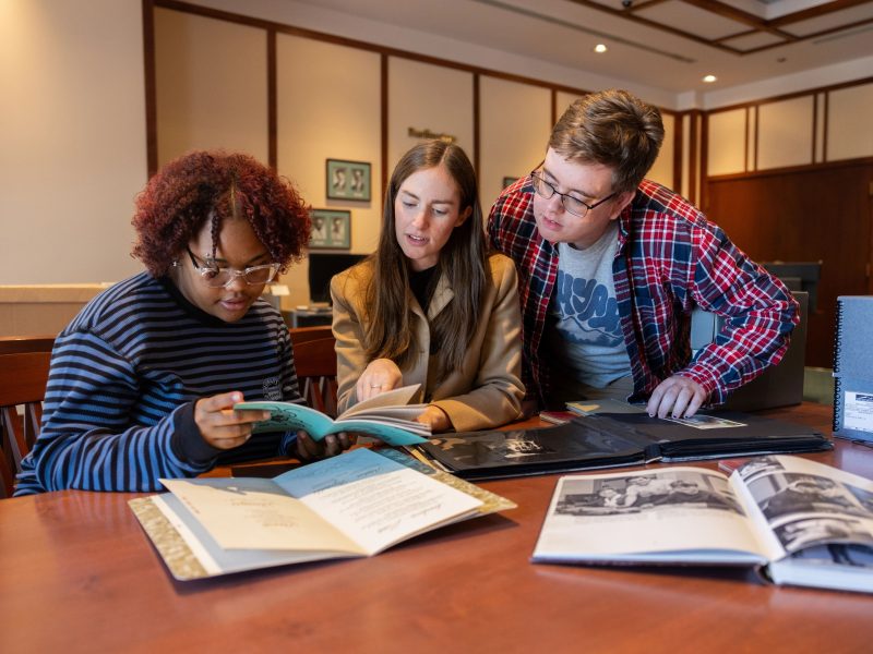 Students and instructor viewing documents in Cline Special Collections.