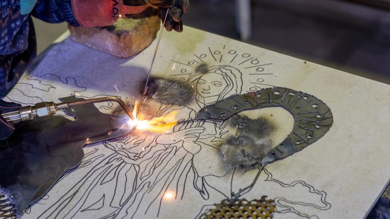 sculpture student welding