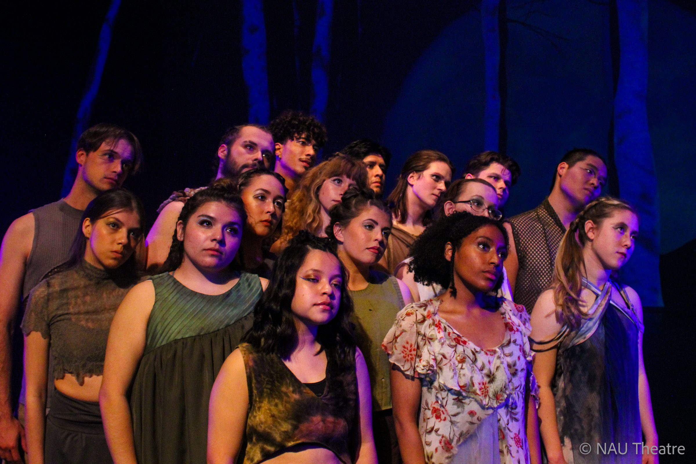 Theater students en masse on stage with dramatic lighting