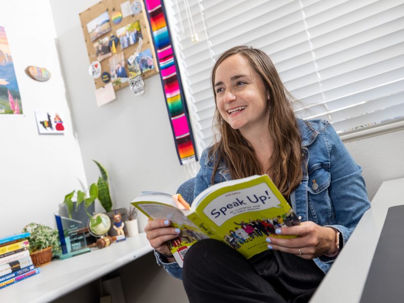 McKenzie McLoughlin reads a book called "Speak Up!" in her office.