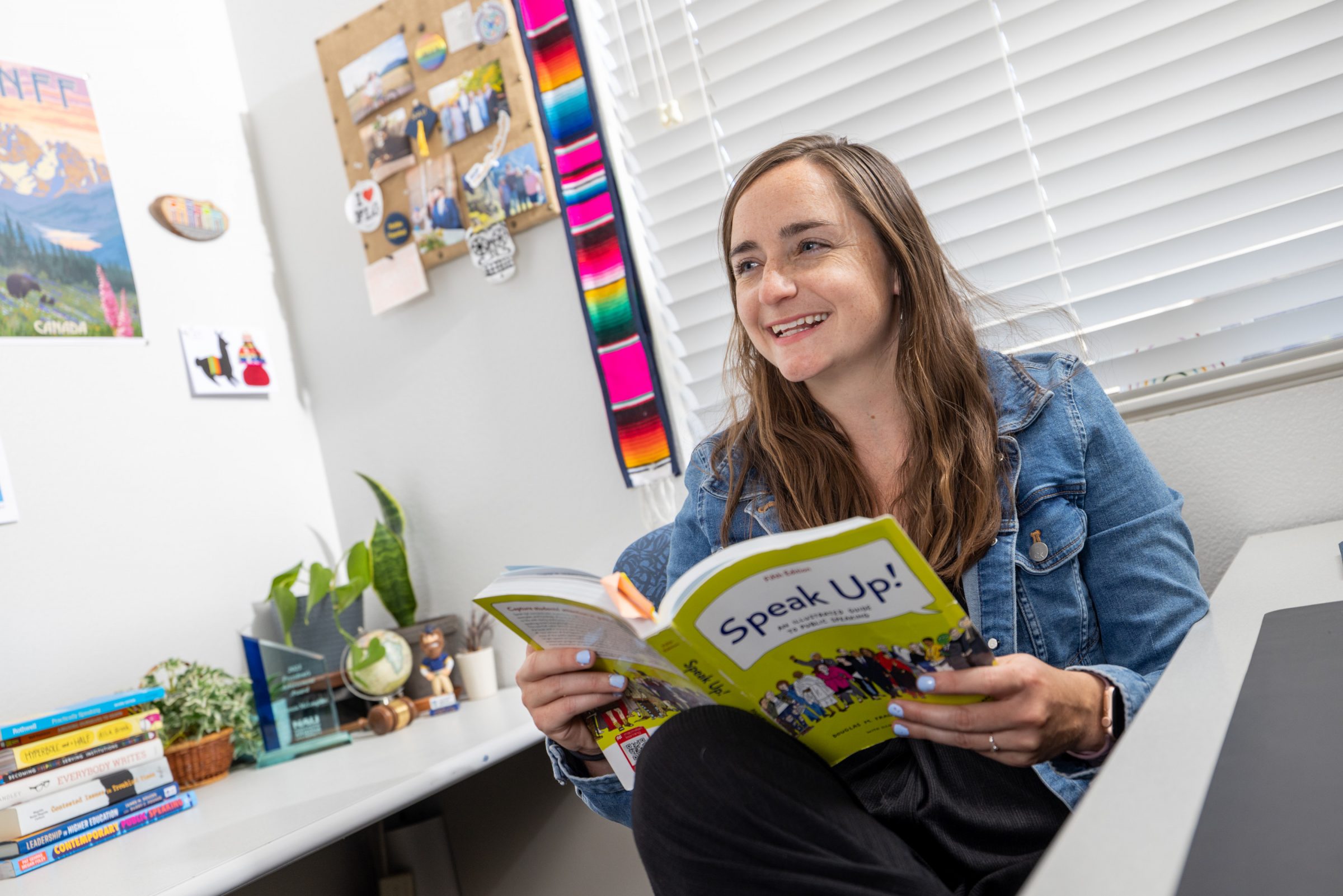 McKenzie McLoughlin reads a book called "Speak Up!" in her office.