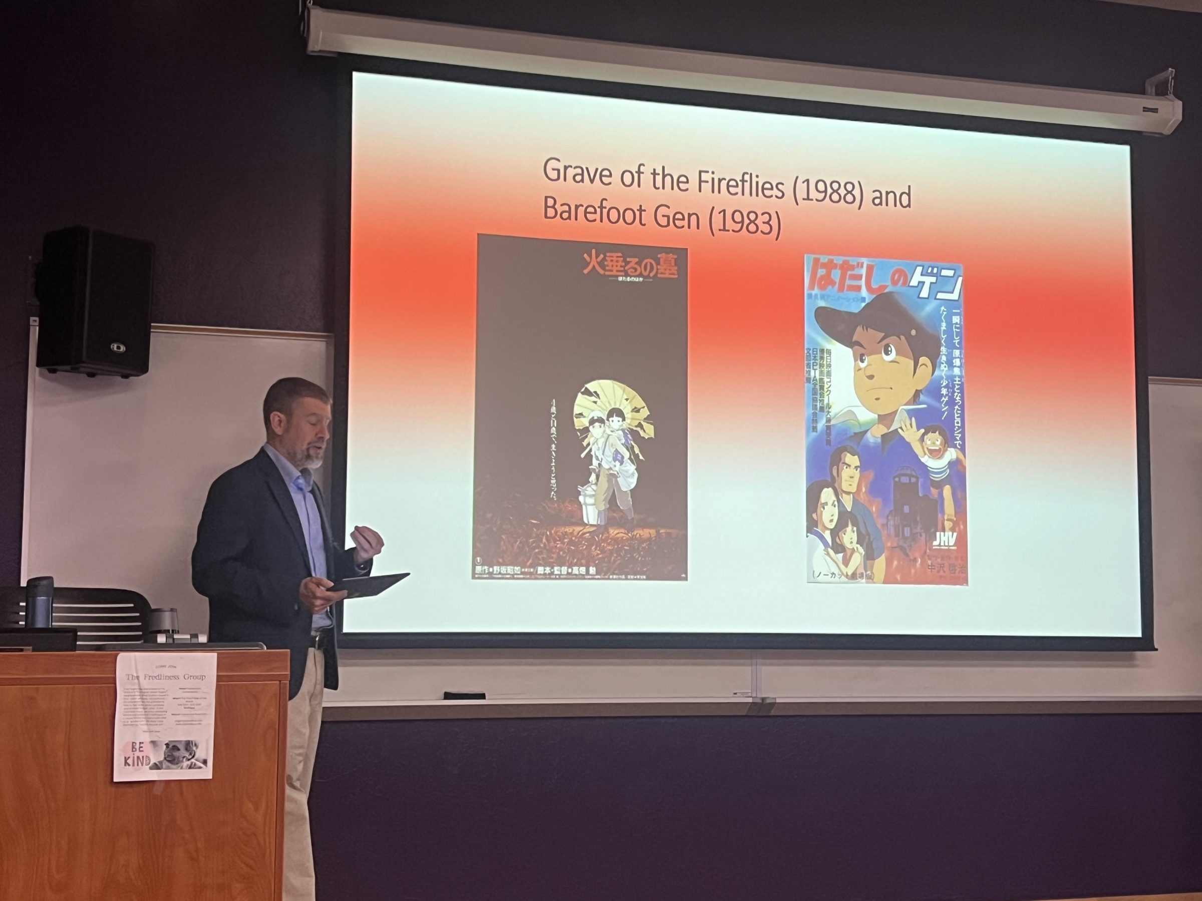 Professor presenting at the front of the room on anime films.